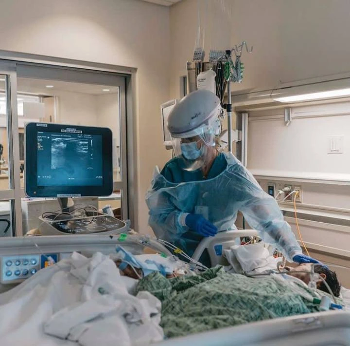 Dr. Chin Donald Kim providing intensive care unit patient treatment in protective medical equipment